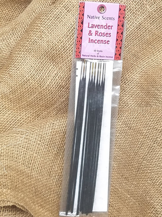 A 10 pack of dark incense sticks in a clear plastic package with lavender and red cardboard label. Background is burlap.